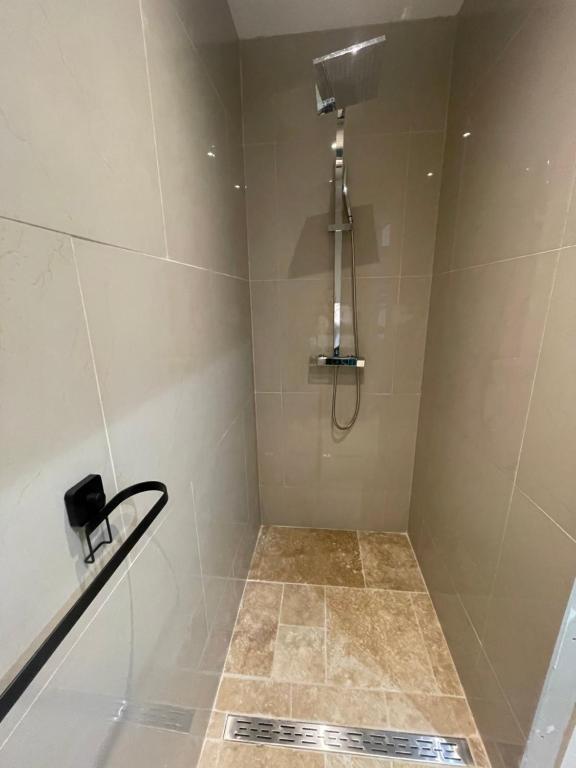 a bathroom with a shower with a shower head at Duplex près de Nantes in Thouaré-sur-Loire
