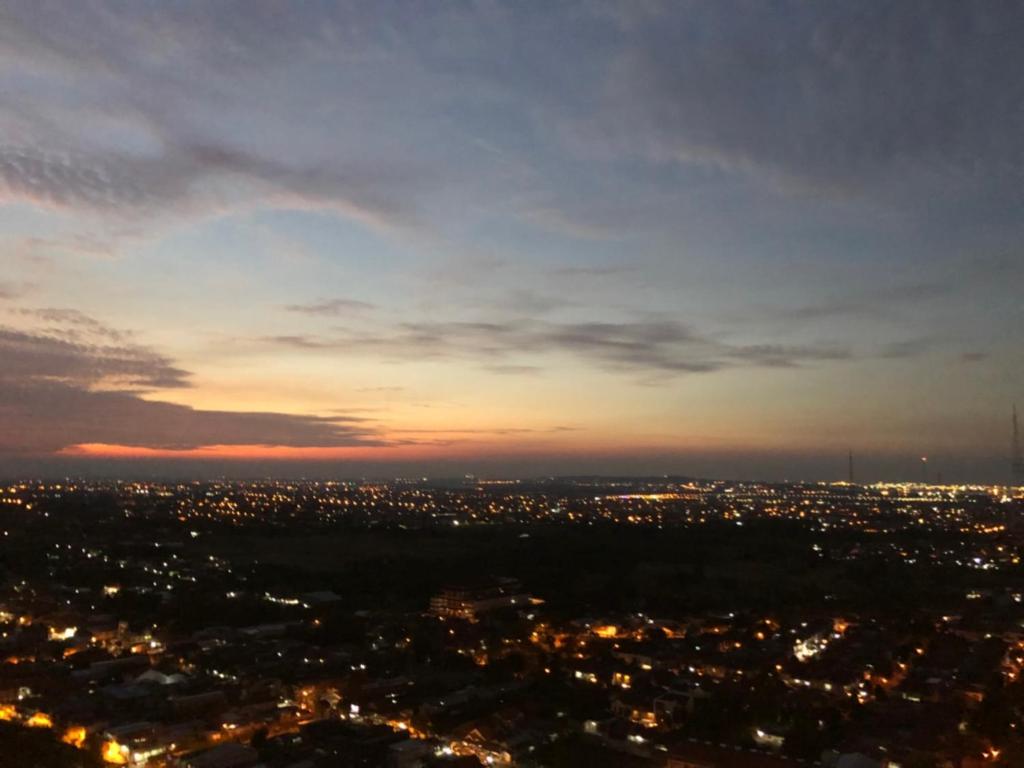 an aerial view of a city at night at Cosmy Tanglin Apartment in Surabaya