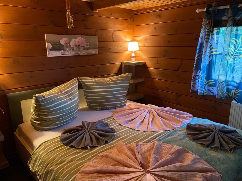 a bedroom with a bed with pillows on it at Naturpark Kanone in Markersdorf