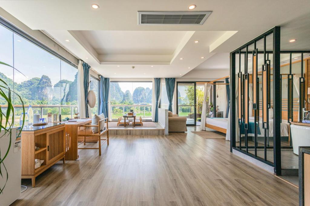 a living room with a view of the mountains at Yangshuo Zen Garden Resort in Yangshuo