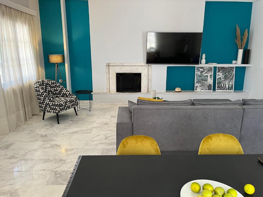 a living room with a couch and a tv at Kalloni Luxury Apartment in Volos