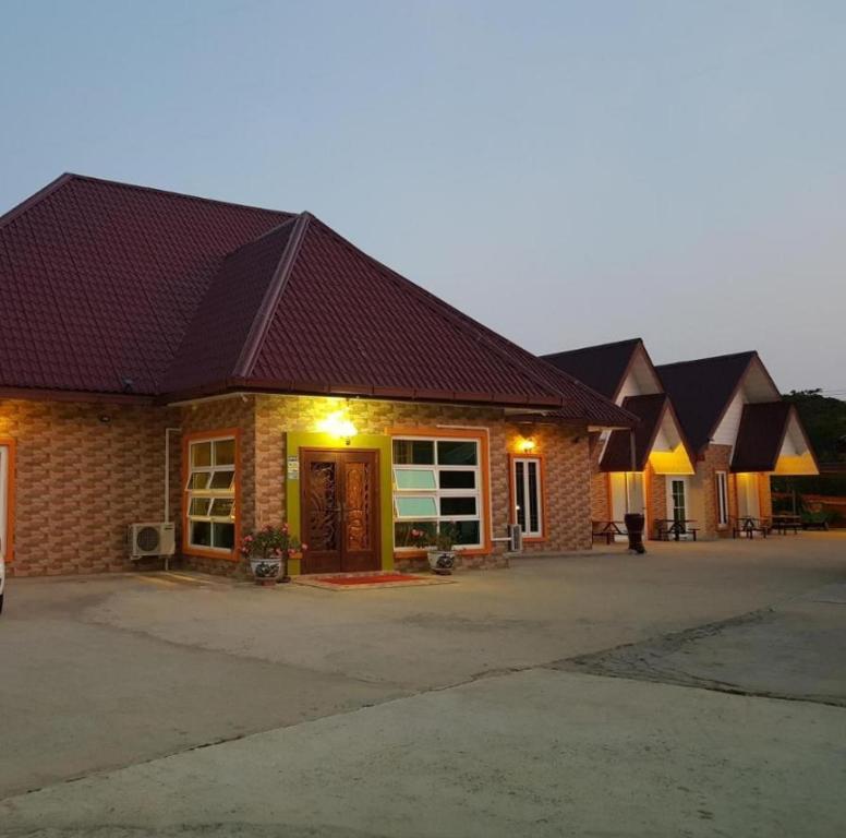 a large brick building with a dark roof at Pilly Homestay in Labuan