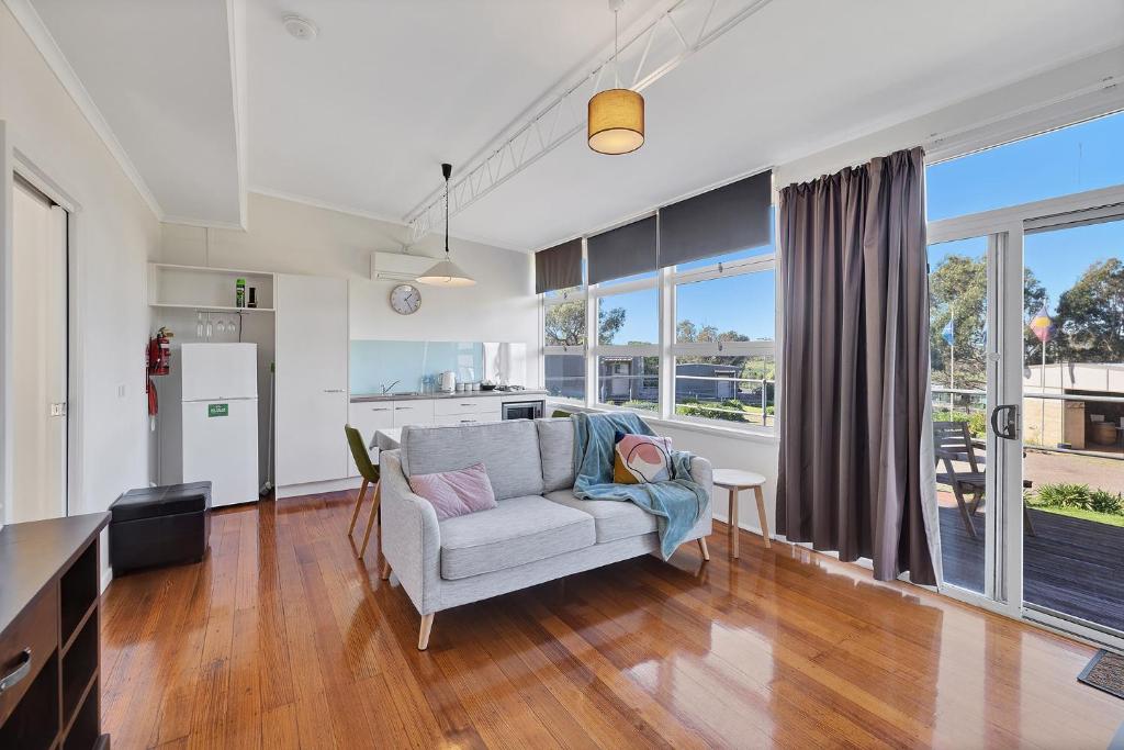 a living room with a couch and a kitchen at Harmony at Tower Hill in Koroit