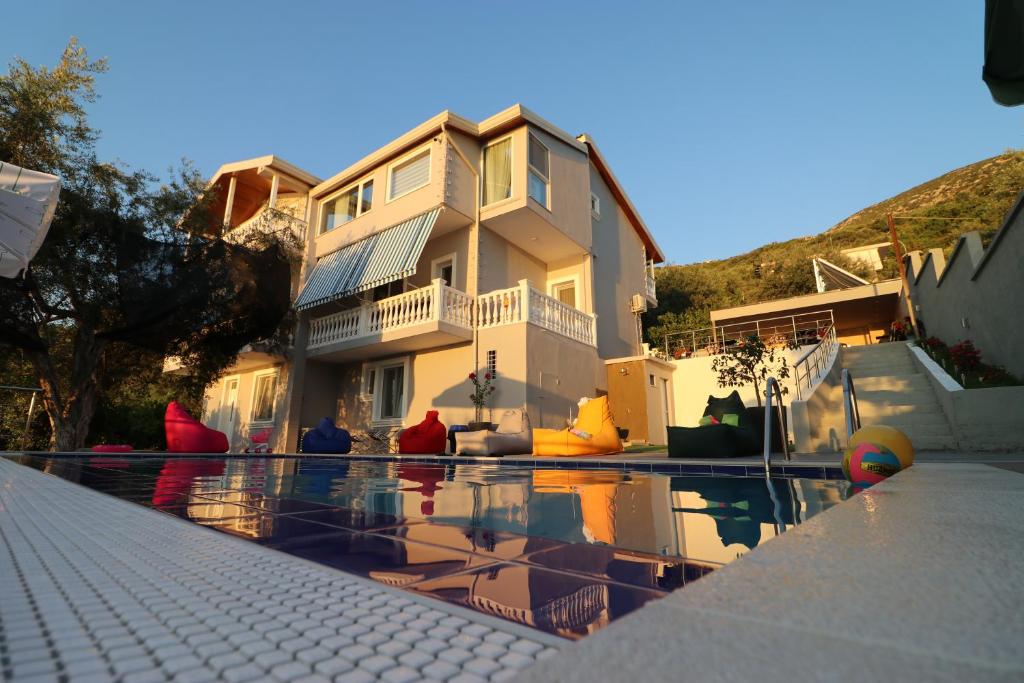 a house with a swimming pool in front of a house at Vila ELARAD in Vlorë