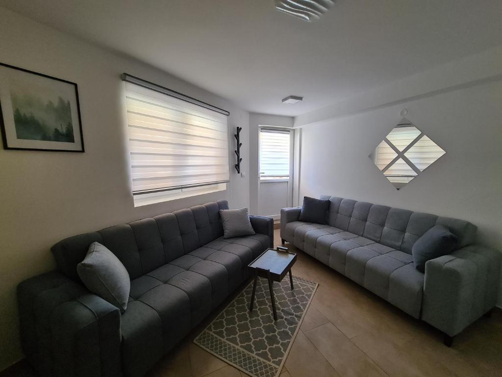 a living room with two couches and a table at Studio MM Kopaonik in Kopaonik