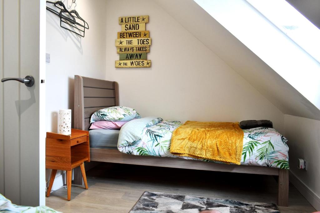 a bedroom with a bed and a chair at The Old Captains Lookout in Falmouth