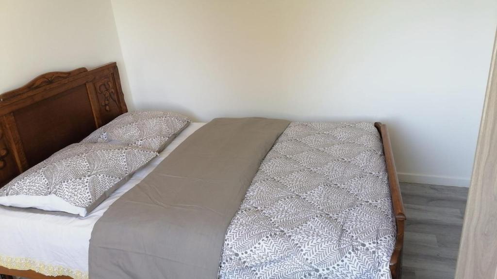 a bed with two pillows on it in a room at Au Bon Vieux Port Maison de vacances Alsacienne à 10mn de Ribeauvillé, Riquewihr et Kaysersberg in Sélestat