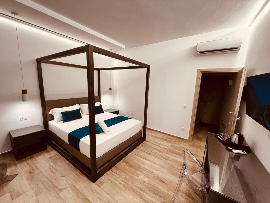 a bedroom with a bed with a large mirror at Suite SWEET DREAMS Dan champs in San Vito lo Capo