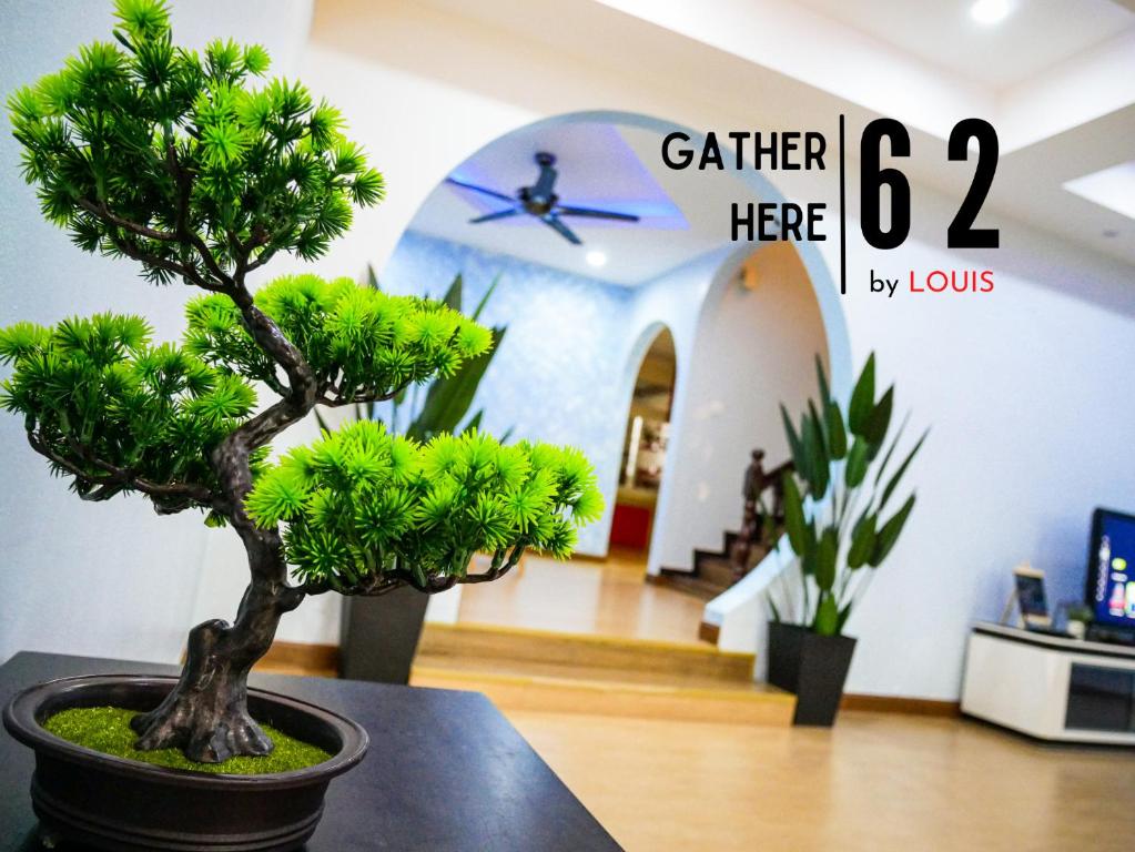 a bonsai tree sitting on a table in a room at Gather Here 62 5BR Town Center 5 Rooms in Taiping