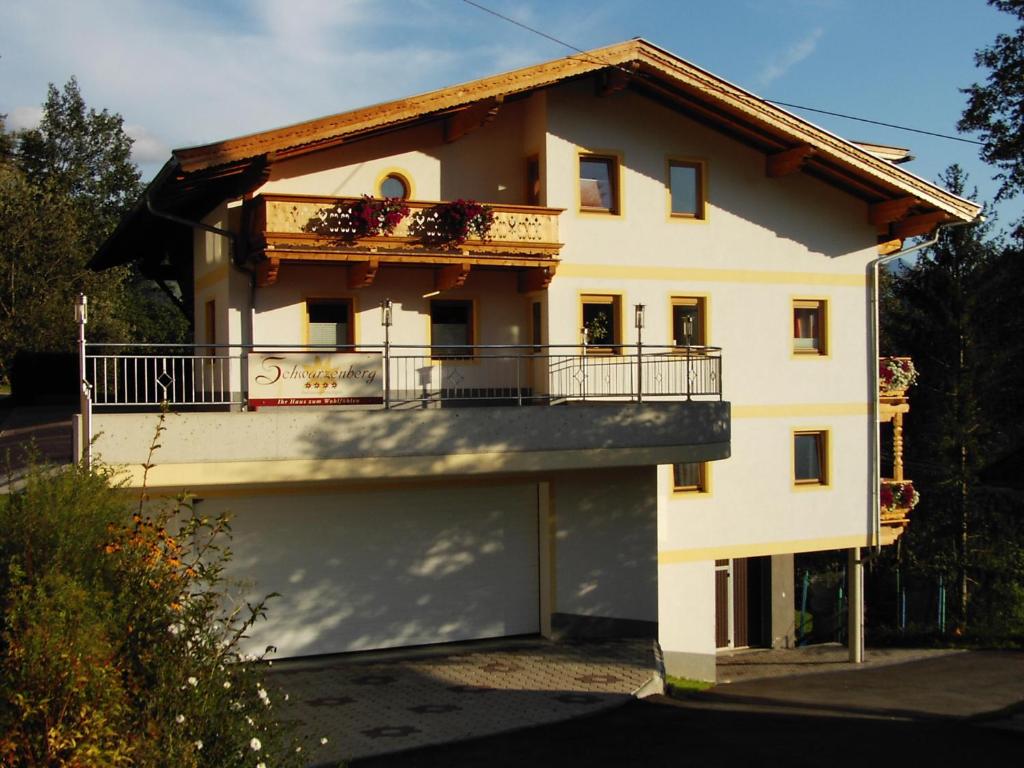 a white house with a balcony on the side of it at Haus Schwarzenberg in Stummerberg