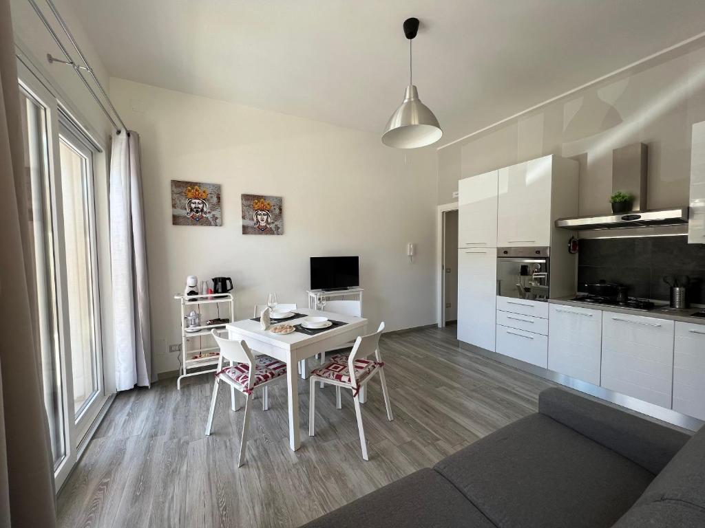 a kitchen and living room with a white table and chairs at Sun Holiday in Avola