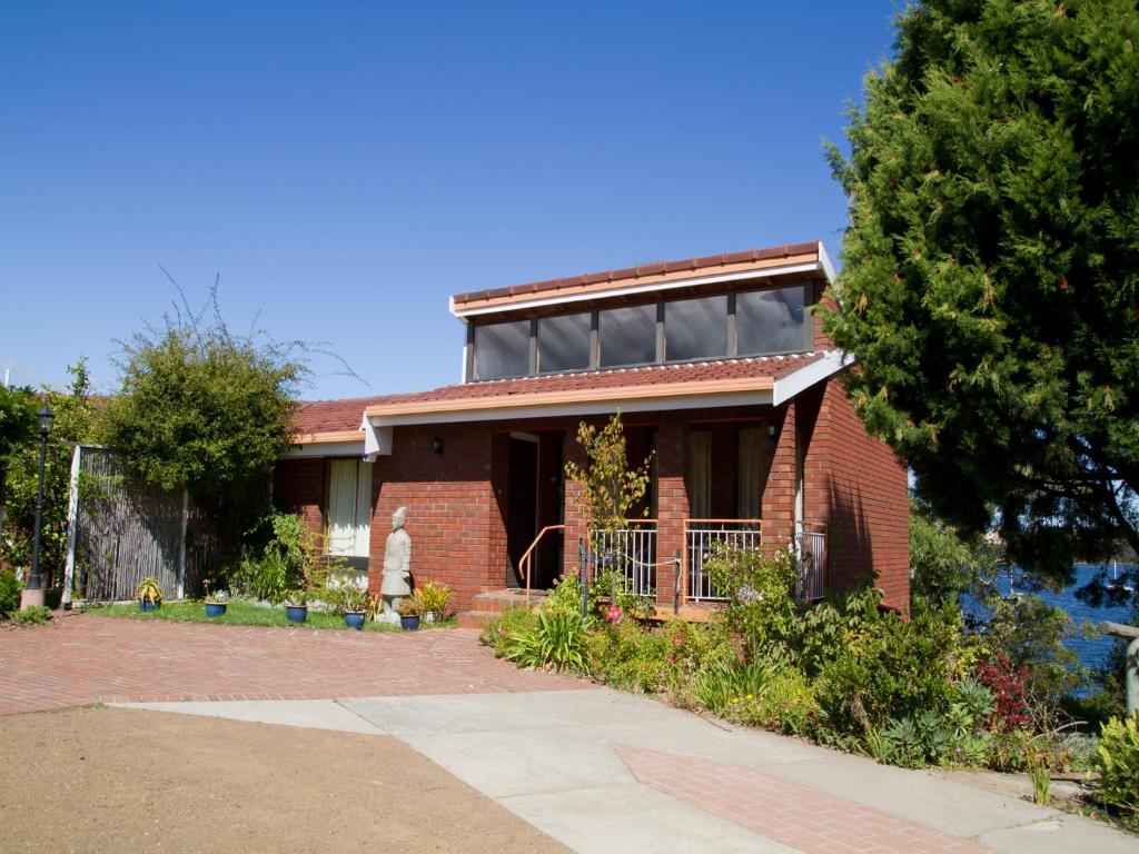 a brick house with a window on top of it at Derwent Retreat in Austins Ferry