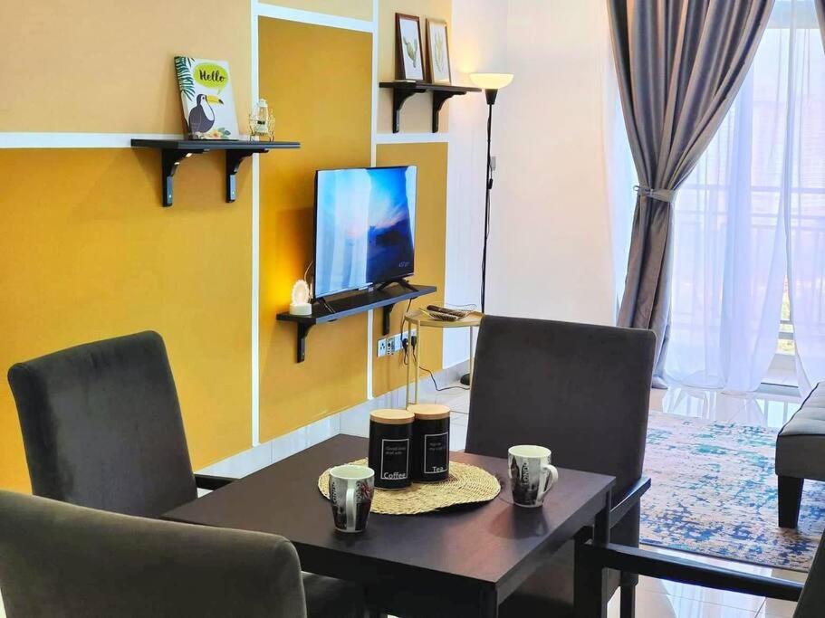 a living room with a table and chairs and a tv at 1601 SKS MidValley Terminal bus NetflixWifi By STAY in Johor Bahru