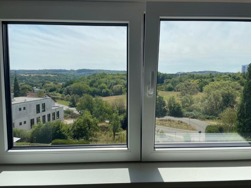 two windows in a room with a view at Ferienhaus Weitblick Sankt Wendel in Sankt Wendel