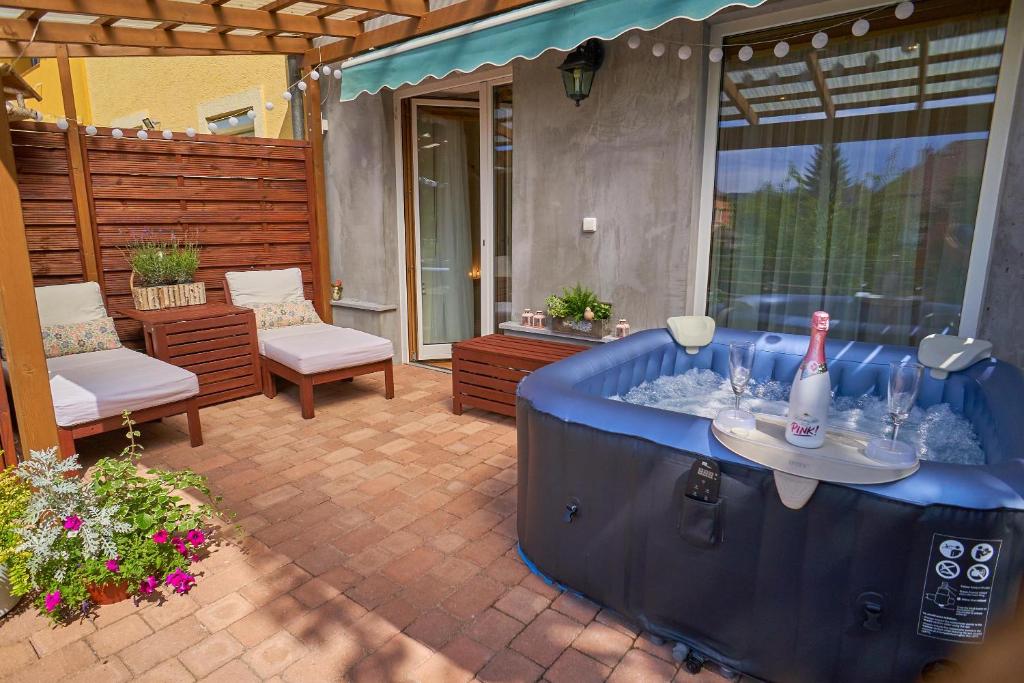 a hot tub sitting on top of a patio at Apartmán Casia in Jeseník