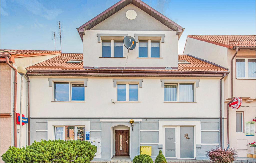 a white house with a red roof at 2 Bedroom Lovely Apartment In Darlowo in Darłowo