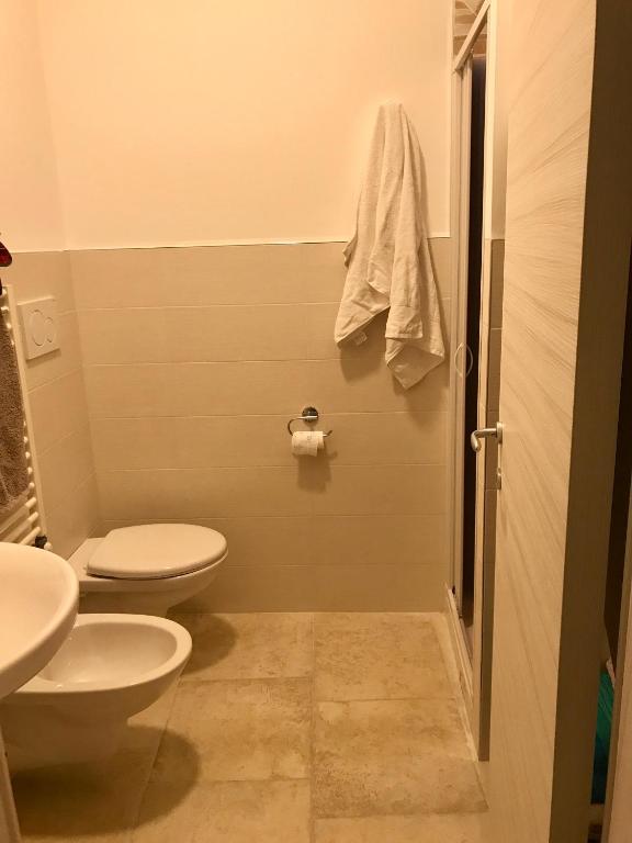 łazienka z 2 toaletami i umywalką w obiekcie Casa Domestico w mieście Monopoli