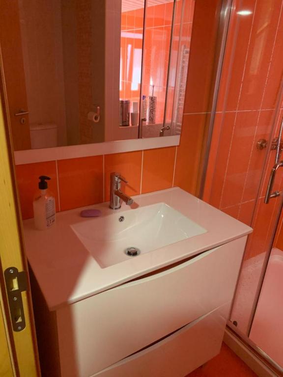 a bathroom with a white sink and a mirror at Casa da Gracita in Pereira