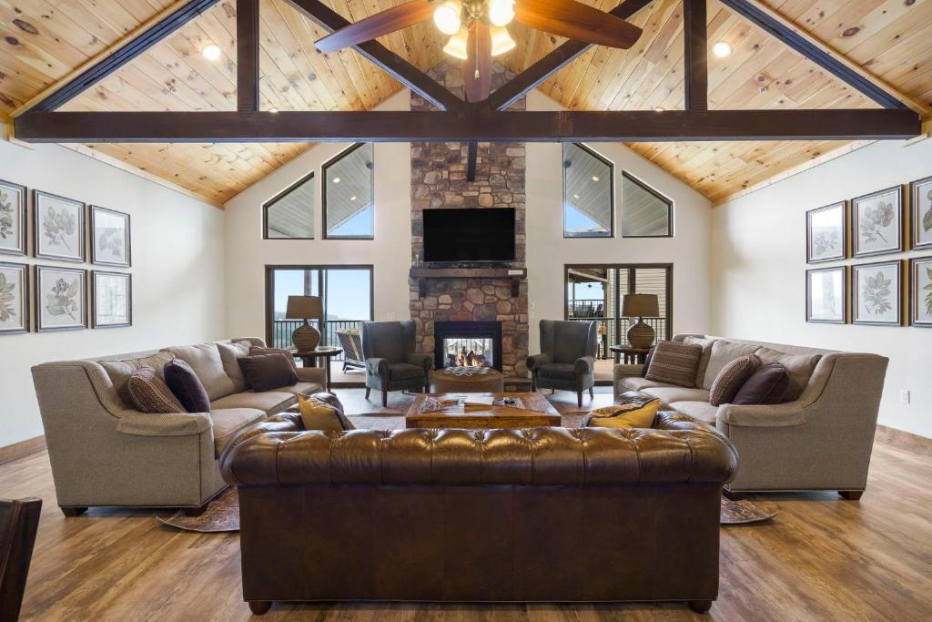 a living room with a couch and a fireplace at Beautiful Branson Lodge Close to All the Action in Branson