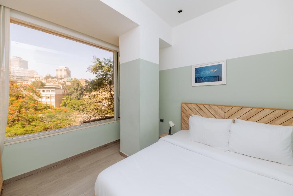 A bed or beds in a room at Brassbell l Zamalek l Jeddah Tower