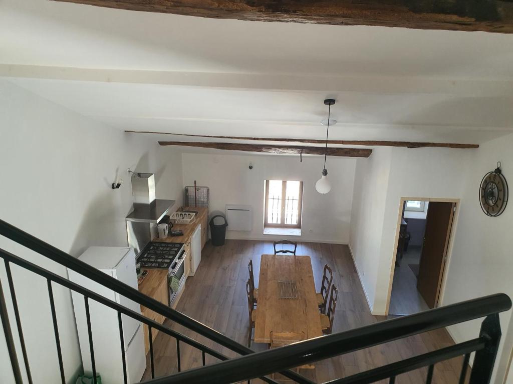 an overhead view of a kitchen and living room with a table at Gîte Manapany in Fains-les-Sources