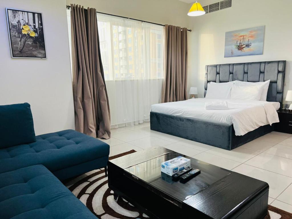 a bedroom with a bed and a couch and a table at Private rooms in 3 bedroom apartment SKYNEST Homes marina pinnacle in Dubai