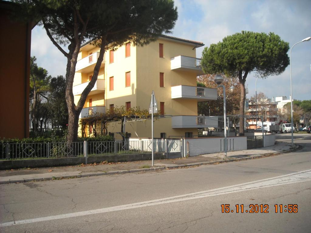 a building on the side of a city street at Amanda Appartamenti in Lido Adriano