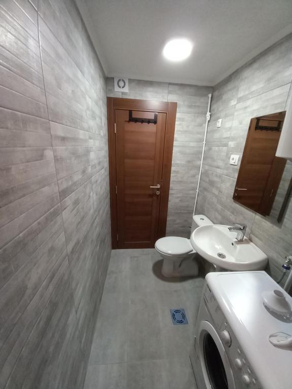 a bathroom with a toilet and a sink at Guest House RG in Žabljak