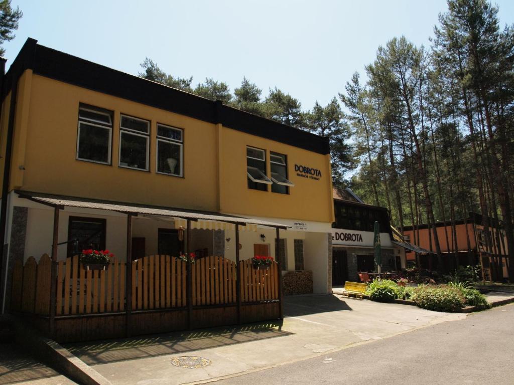 a yellow building with a fence in front of it at RS Dobrota in Staré Splavy