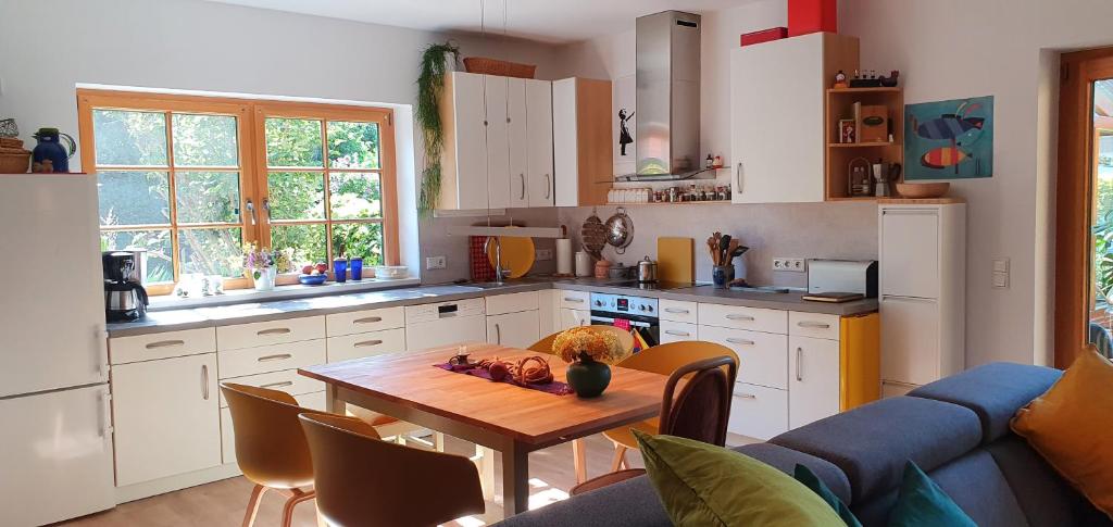 a kitchen with a table and a blue couch at Ferienwohnung Wybo mit Garten in Wremen