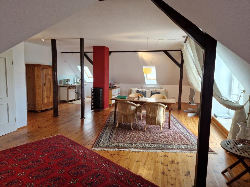 a living room with a table and a dining room at Ferienwohnung mit Flair in Dresden