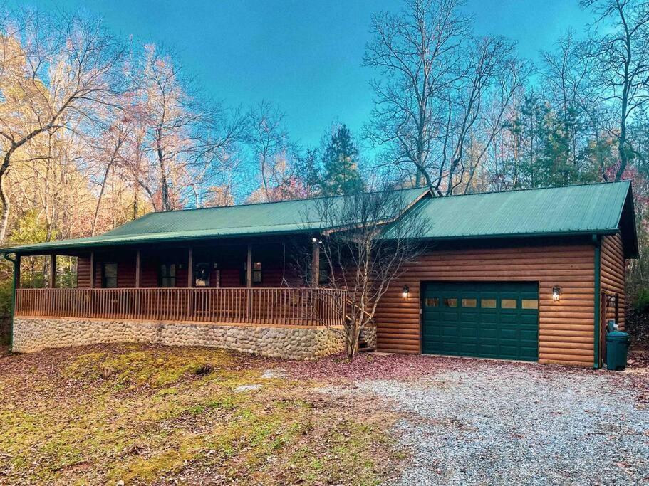 a house with a garage in the woods at Hibernation Hideaway in Blairsville