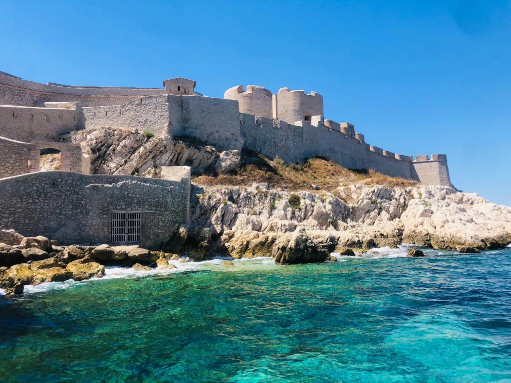 a castle on a cliff next to the water at la daurade du frioul , île du Frioul, marseille in Marseille