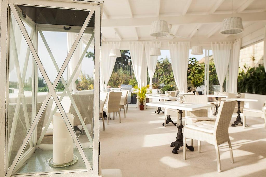 a mirror in a dining room with tables and chairs at Tenuta Del Poggio Antico in Ischia