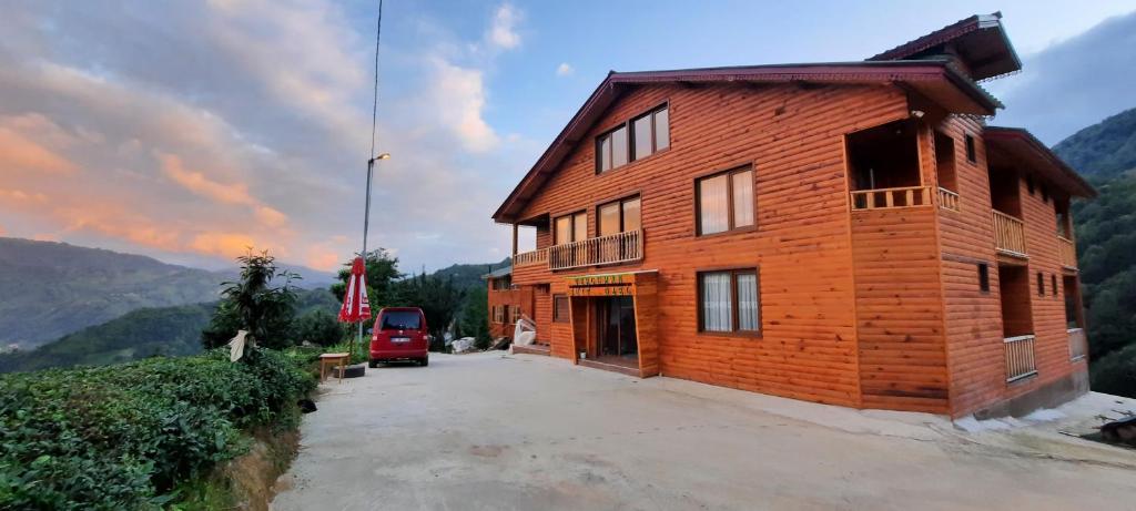a wooden building with a car parked in front of it at Tercuman Suit Otel in Ardeşen