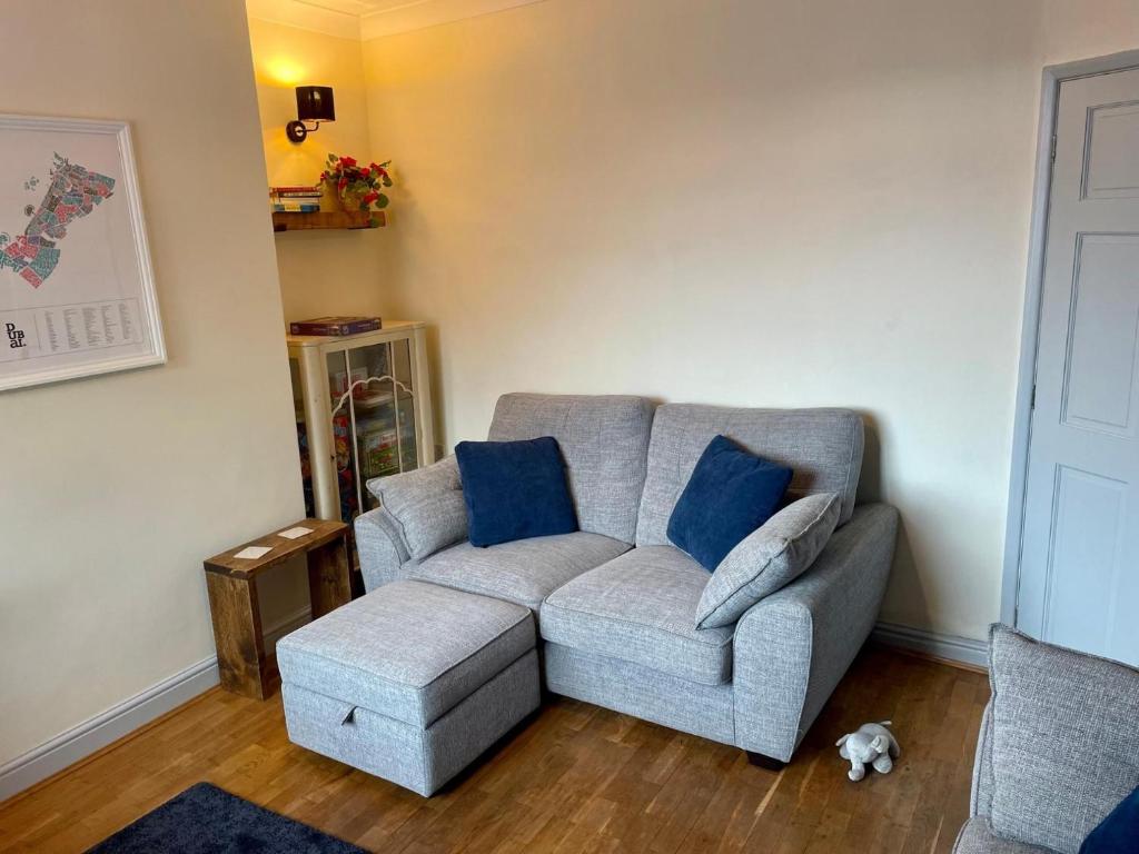 a living room with a gray couch and blue pillows at Lovely 3BD Home in the Heart of Morton in Morton