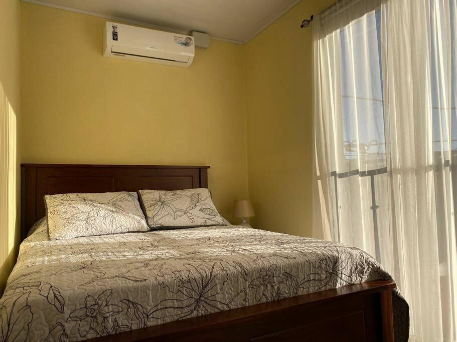 a bedroom with a bed next to a window at Airport SJO Residence - Edward & Familia Inn in Alajuela