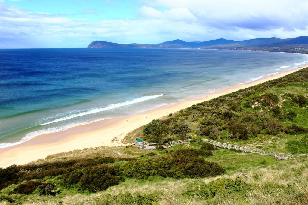 an aerial view of a beach and the ocean at Bruny Island Oceanfront Luxe Cabin with Spa in Adventure Bay