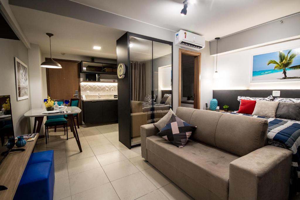 a living room with a couch and a dining room at SMART Flats - Decorado Superior - 11º andar - Esplanada - Saint Moritz in Brasilia