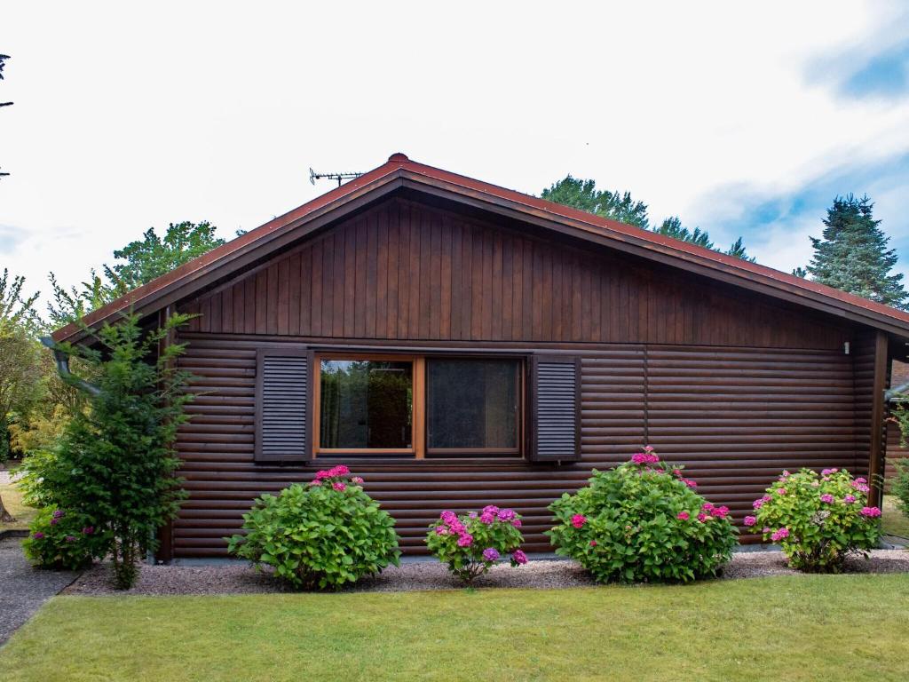 a small house with flowers in front of it at House, Suhlendorf in Suhlendorf