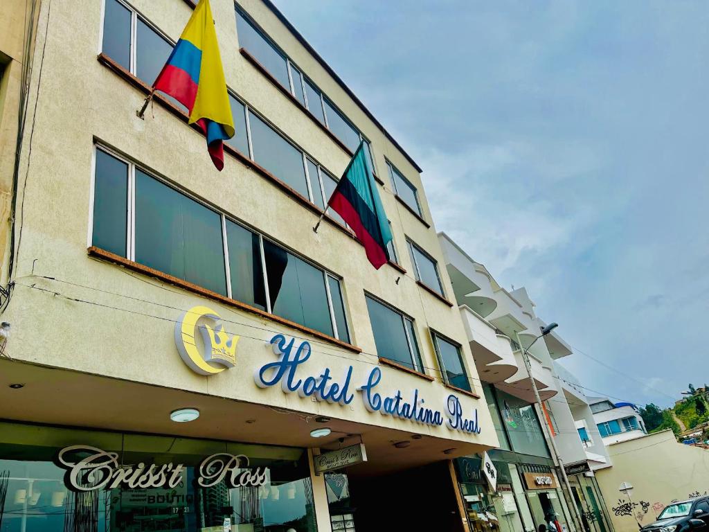 a hotel with two flags on the side of a building at Hotel Catalina Real in Duitama