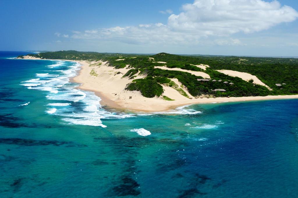 an aerial view of an island in the ocean at Machangulo Beach Lodge in Santa Maria