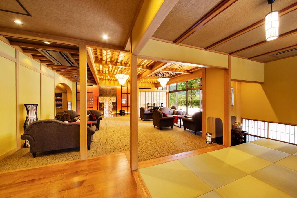 a large living room with couches and chairs at Kanazawa Hyakurakusou in Kanazawa
