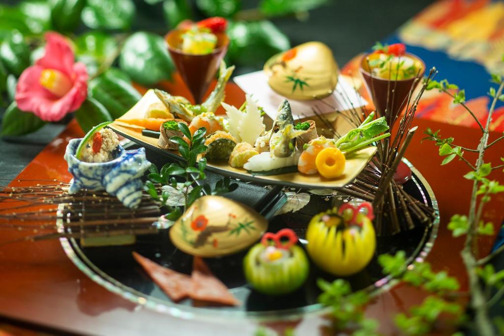 a table with two plates of food on a table at Kanazawa Hyakurakusou in Kanazawa