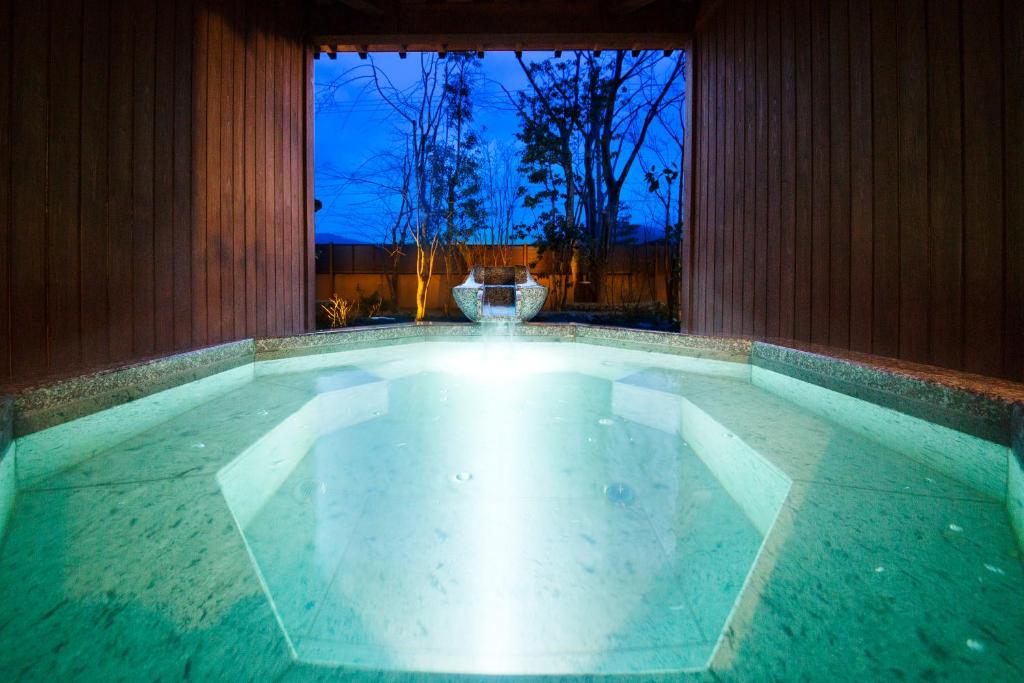 a large pool of water in a room with a window at Kanazawa Hyakurakusou in Kanazawa
