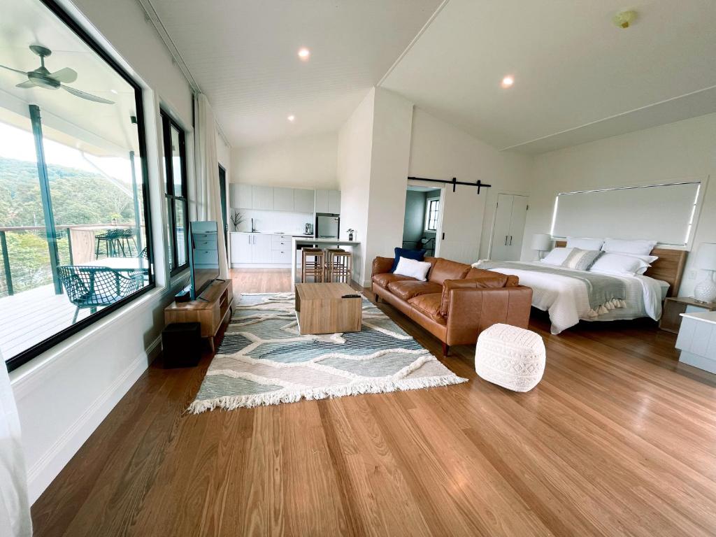 a large living room with a bed and a couch at Seven Peaks Farm Stay in Beerwah