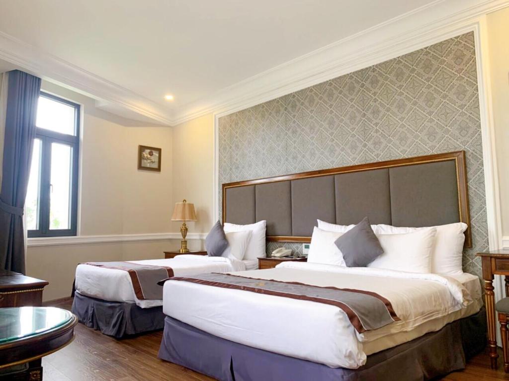 Voodi või voodid majutusasutuse AVS Hotel Phu Quoc toas