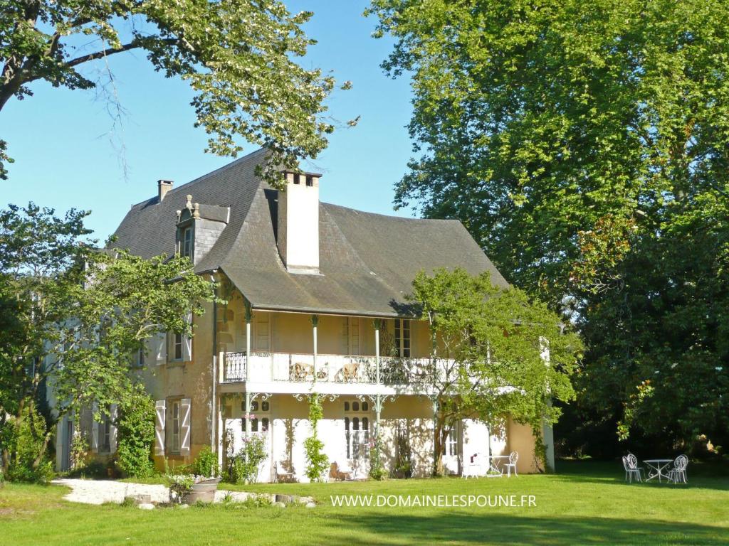 a large house with a gambrel roof at Domaine Lespoune in Castetnau-Camblong