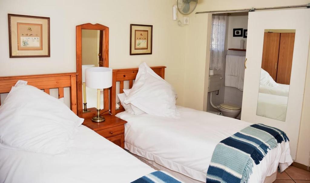 two beds sitting next to each other in a bedroom at Siesta B&B Vryheid in Vryheid