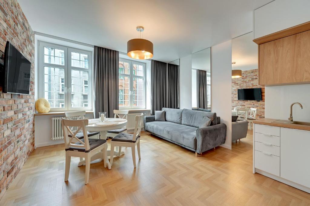 a living room with a couch and a table at Downtown Apartments Old Town Mariacka in Gdańsk